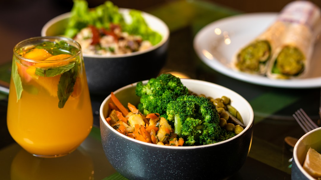 A bowl of green vegetables on a white ceramic dish